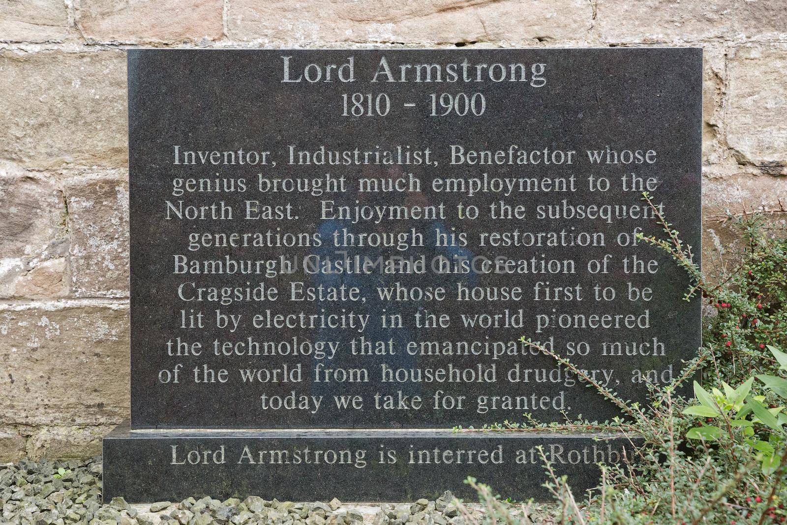 BAMBURGH, NORTHUMBERLAND, ENGLAND, UK - SEPTEMBER 10, 2017: Stone in memory for Lord Armstrong the first baron of Bamburgh Castle in Northumberland, England, UK.