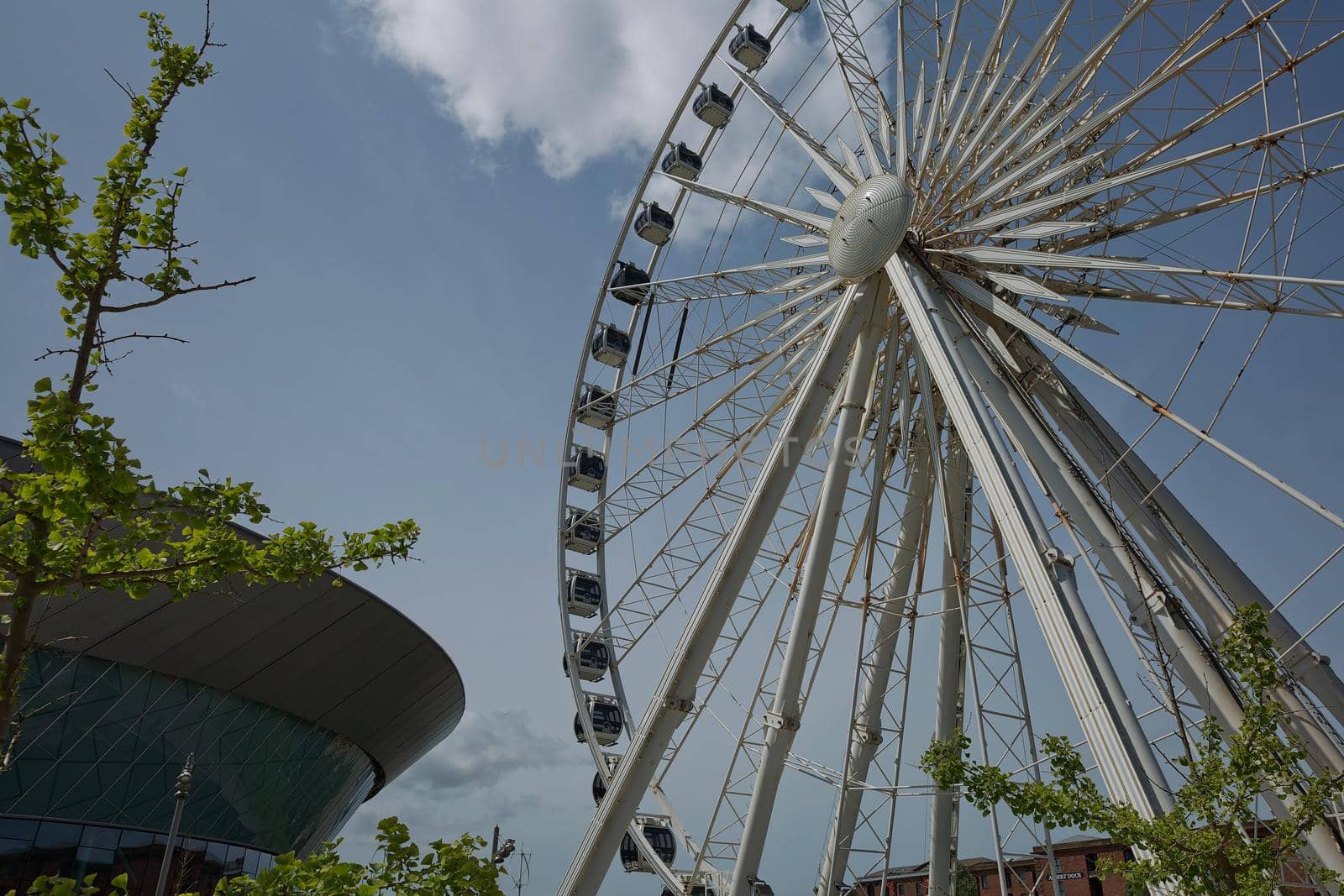 View of the ECHO convention center and an adjacent ferris wheel in Liverpool, England by wondry