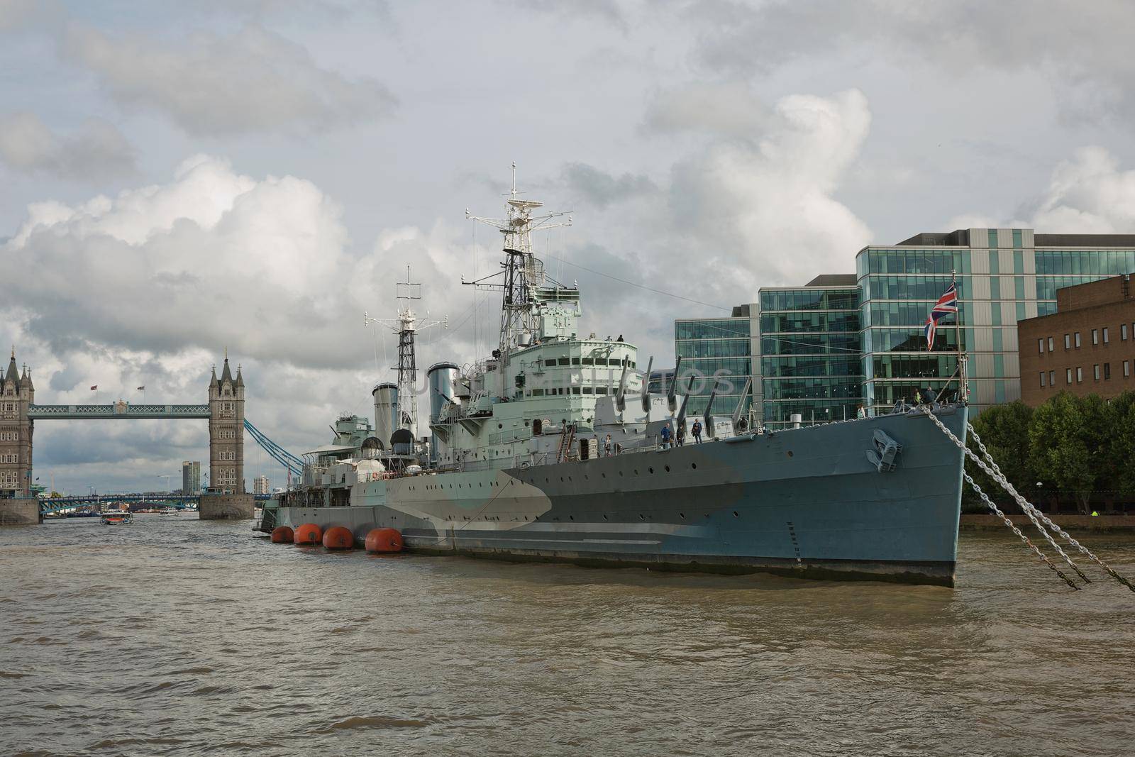 LONDON, UK - SEPTEMBER 08, 2017: HMS Belfast war ship on the Thames river with in London with the Tower bridge in the background.