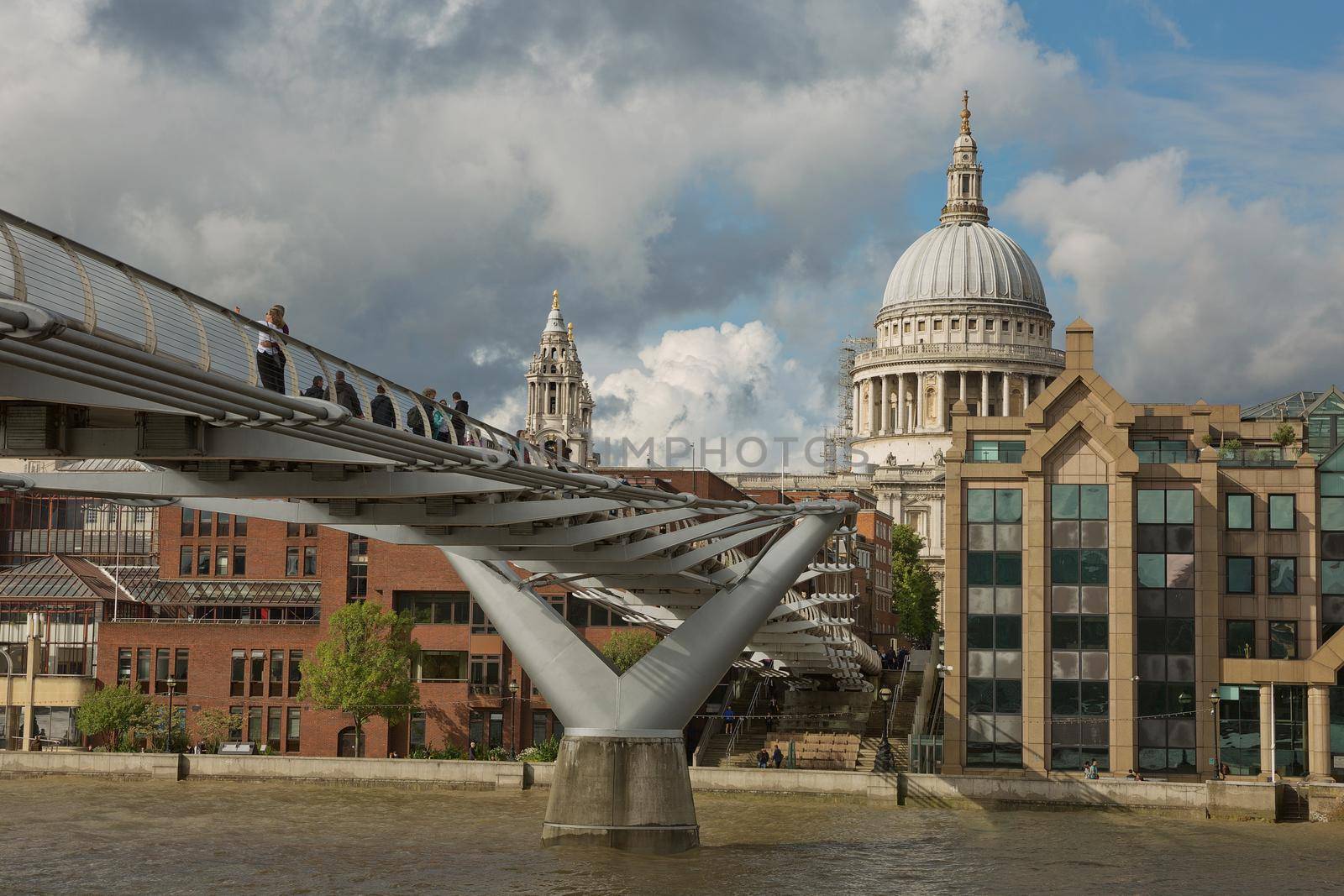 LONDON, UK - SEPTEMBER 08, 2017: St Pauls Cathedral and the Millennium Bridge in London, United Kingdom during a cloudy day.