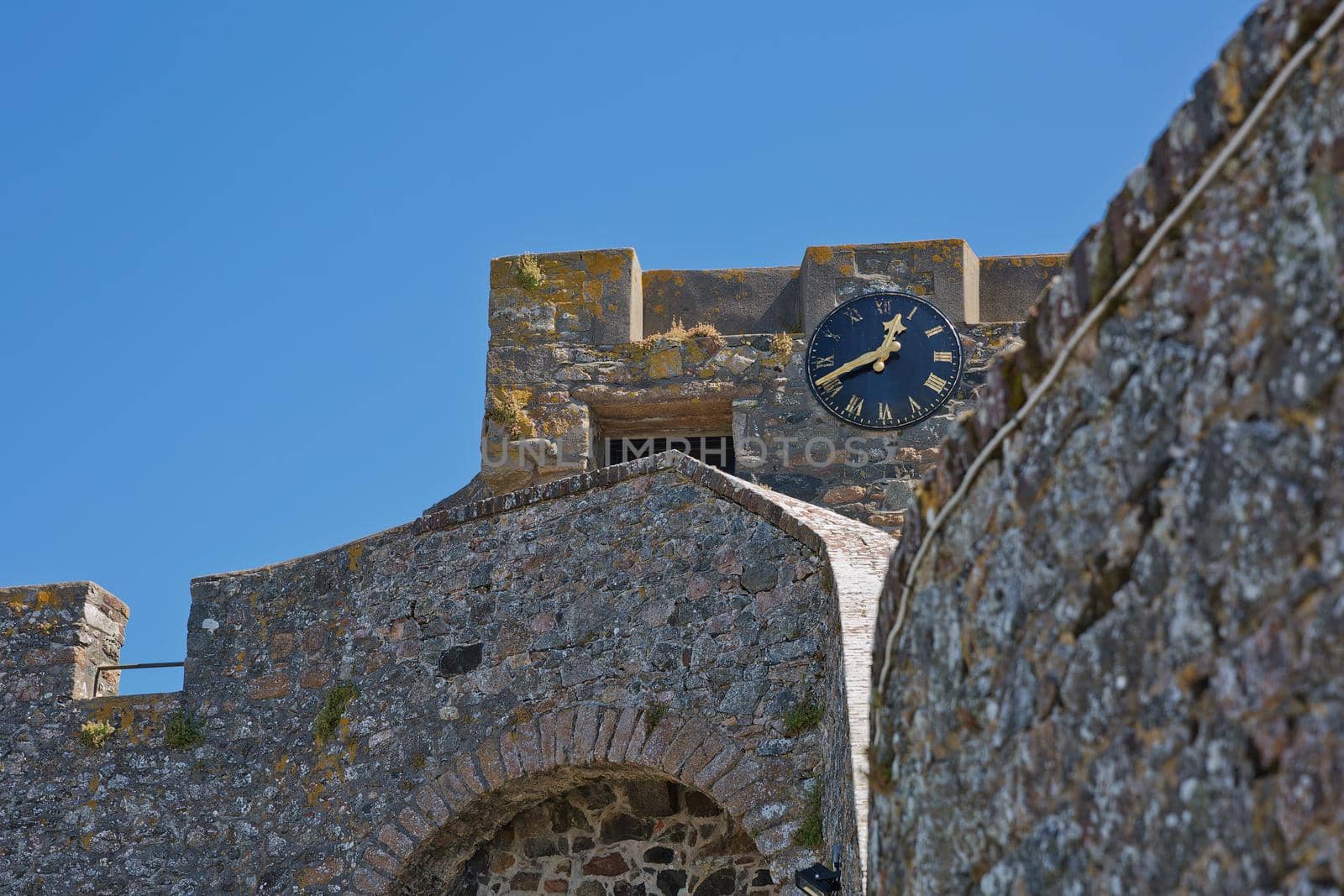 A Clock on the walls of Castle Cornet in St Peter Port, Guernsey, UK by wondry