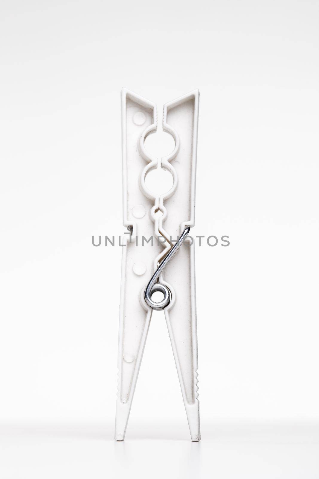 white clothes peg against white background