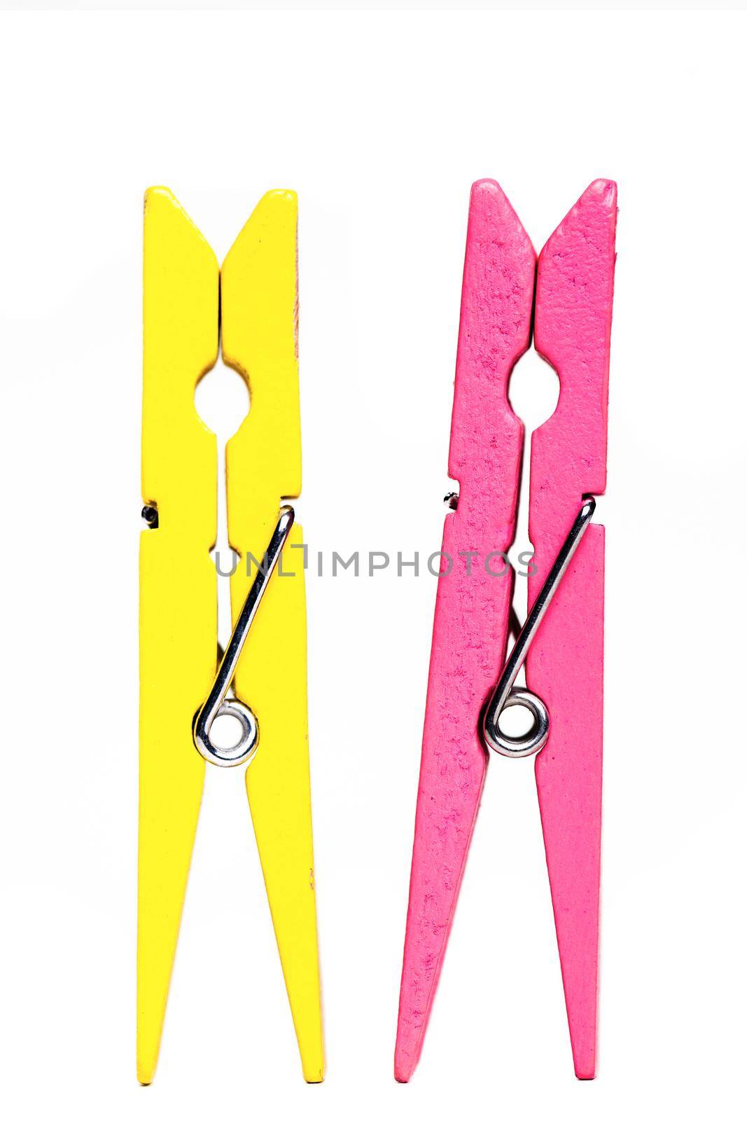 yellow and pink clothes pegs isolated on white background