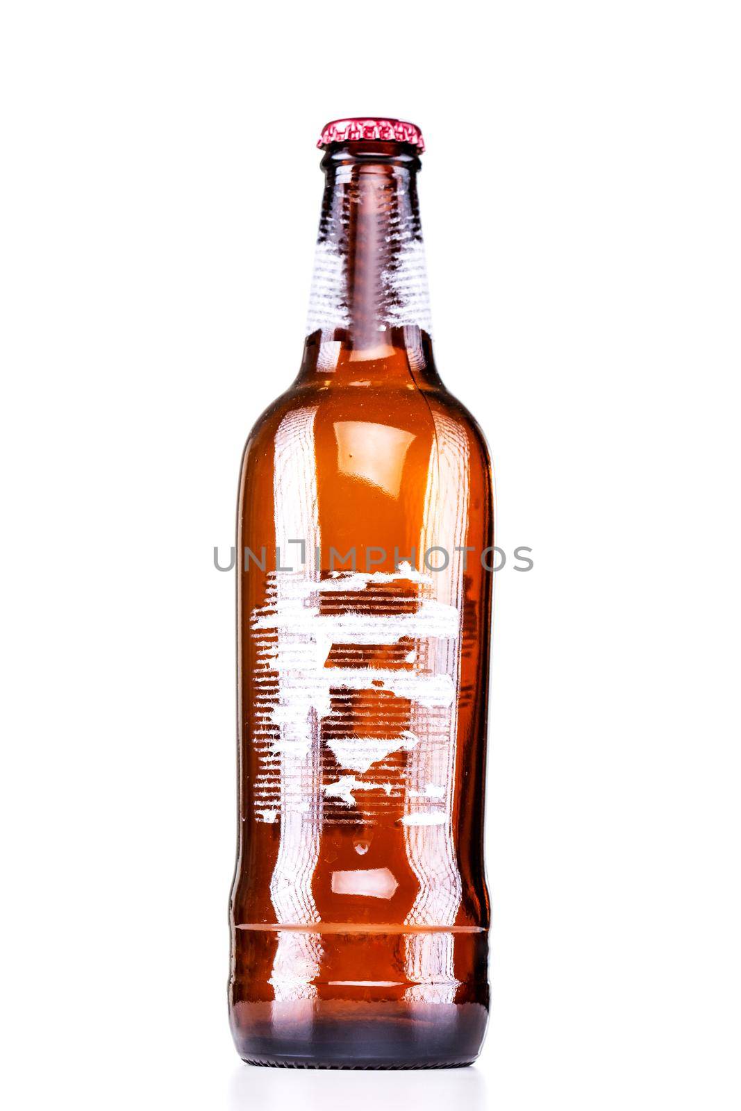 beer bottle with torn label isolated on white