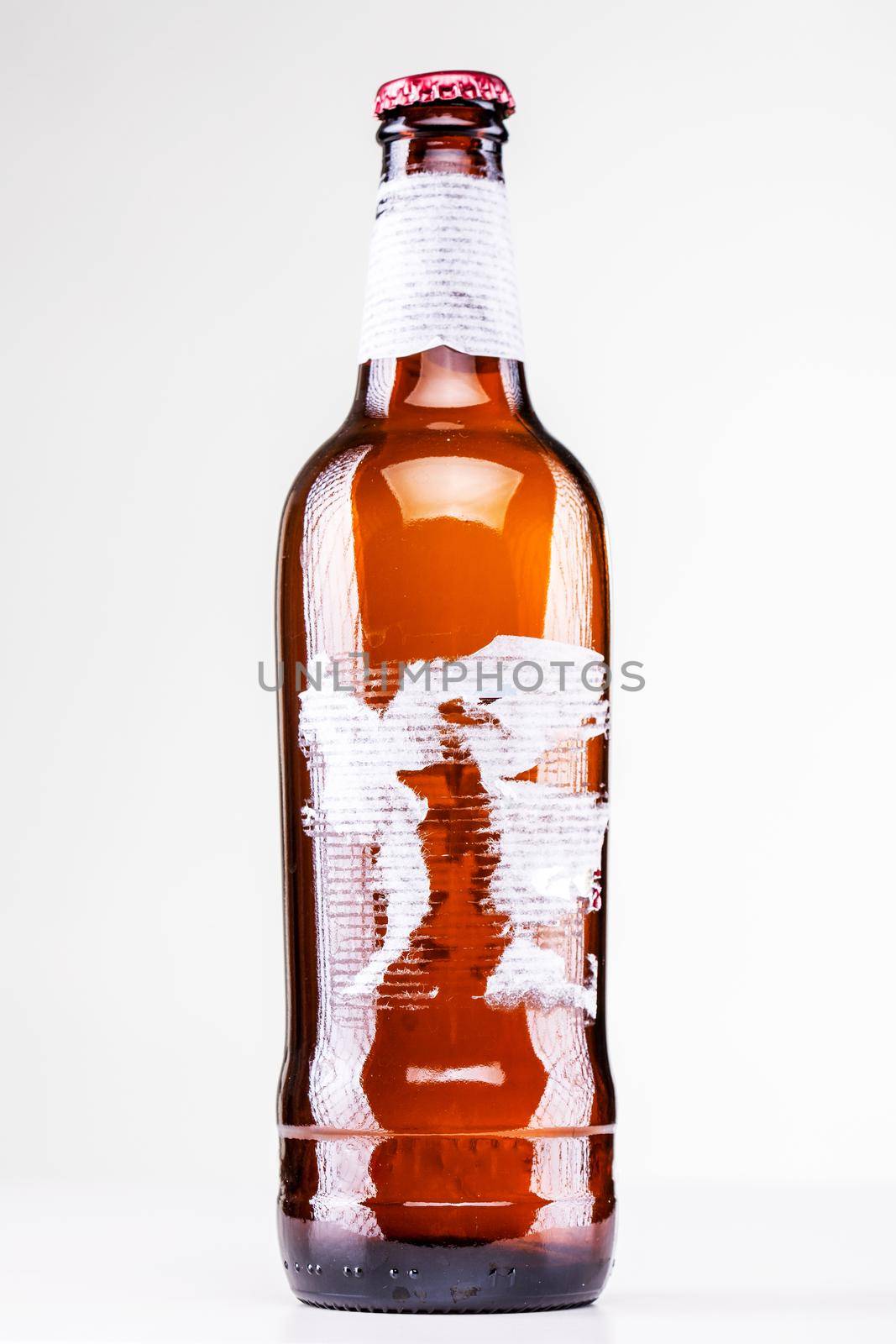 beer bottle with torn label isolated on white