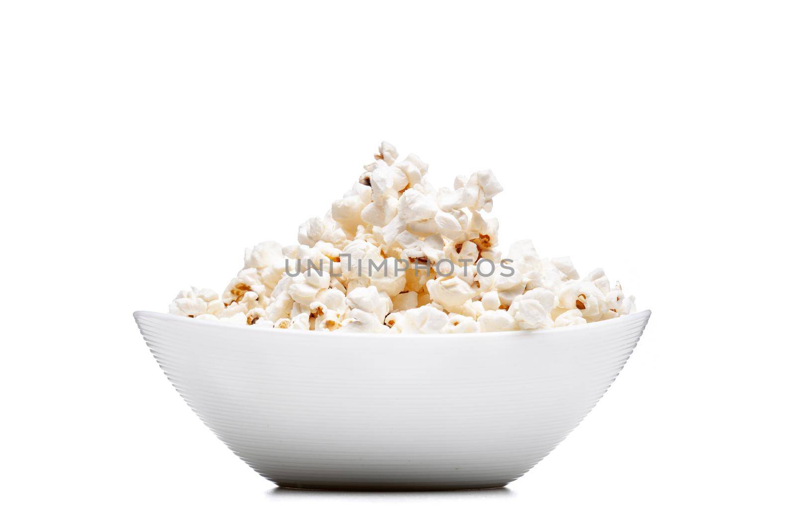 white bowl with popcorn against white background