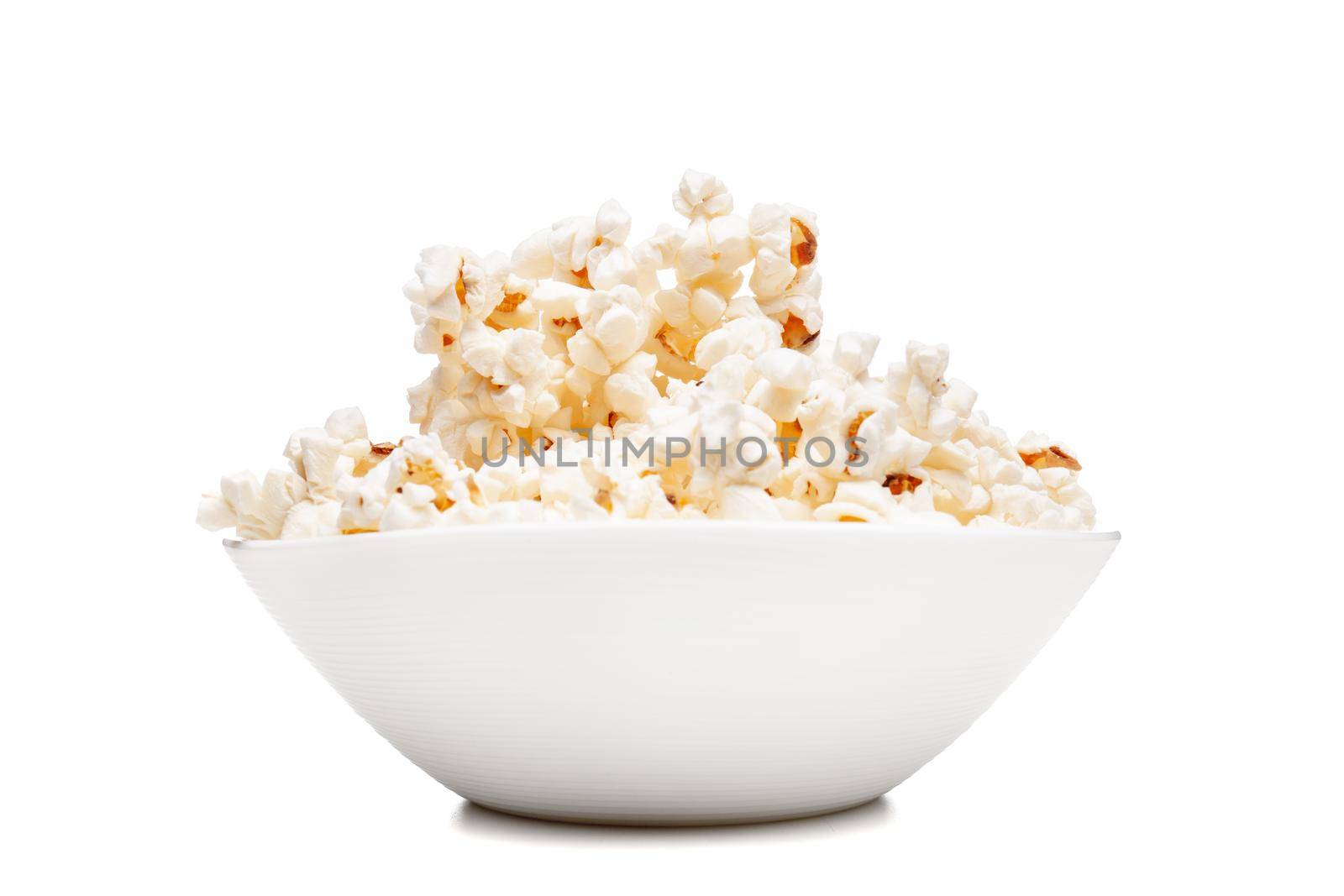 white bowl with popcorn against white background