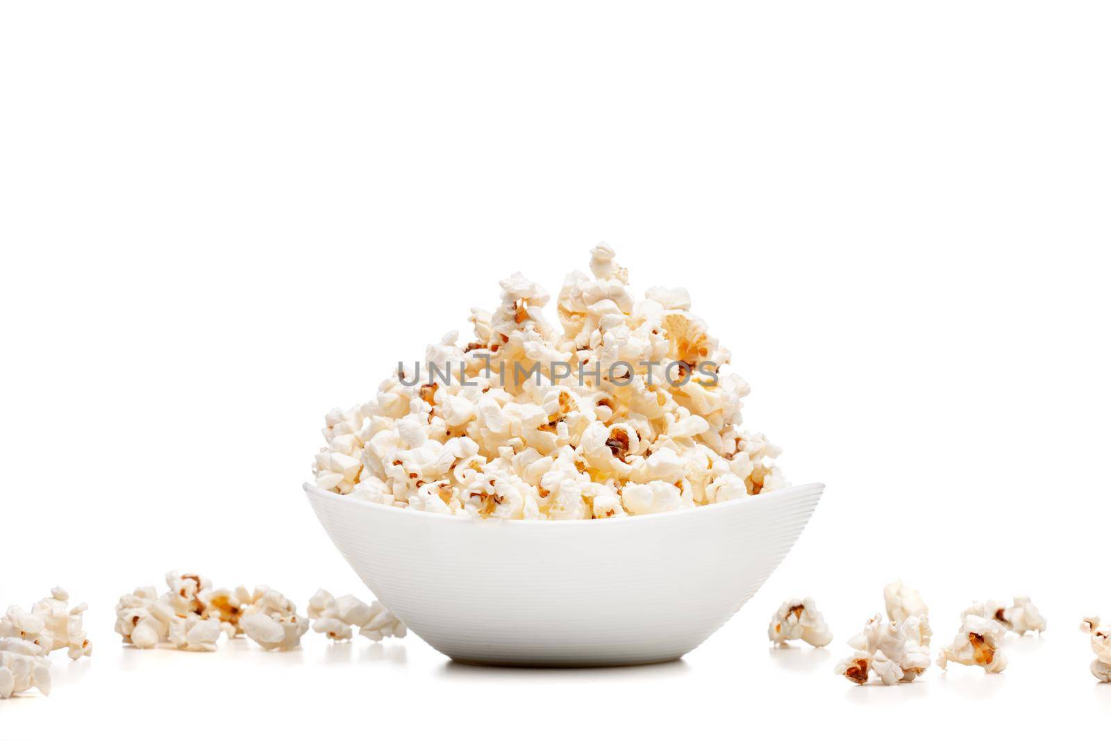 white bowl with popcorn against white background