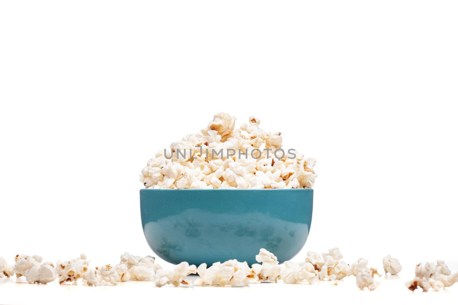 blue bowl with popcorn against white background