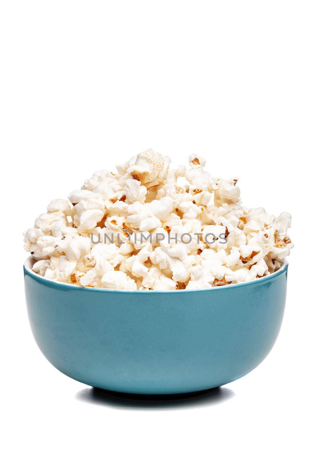 blue bowl with popcorn against white background