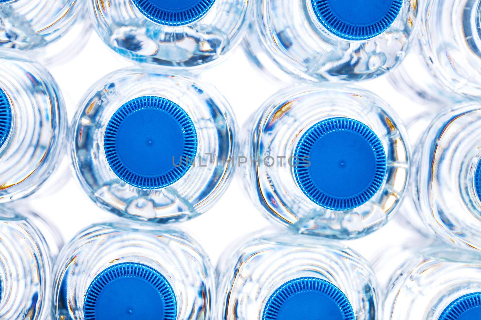 pile of plastic bottles of half litre with blue cap