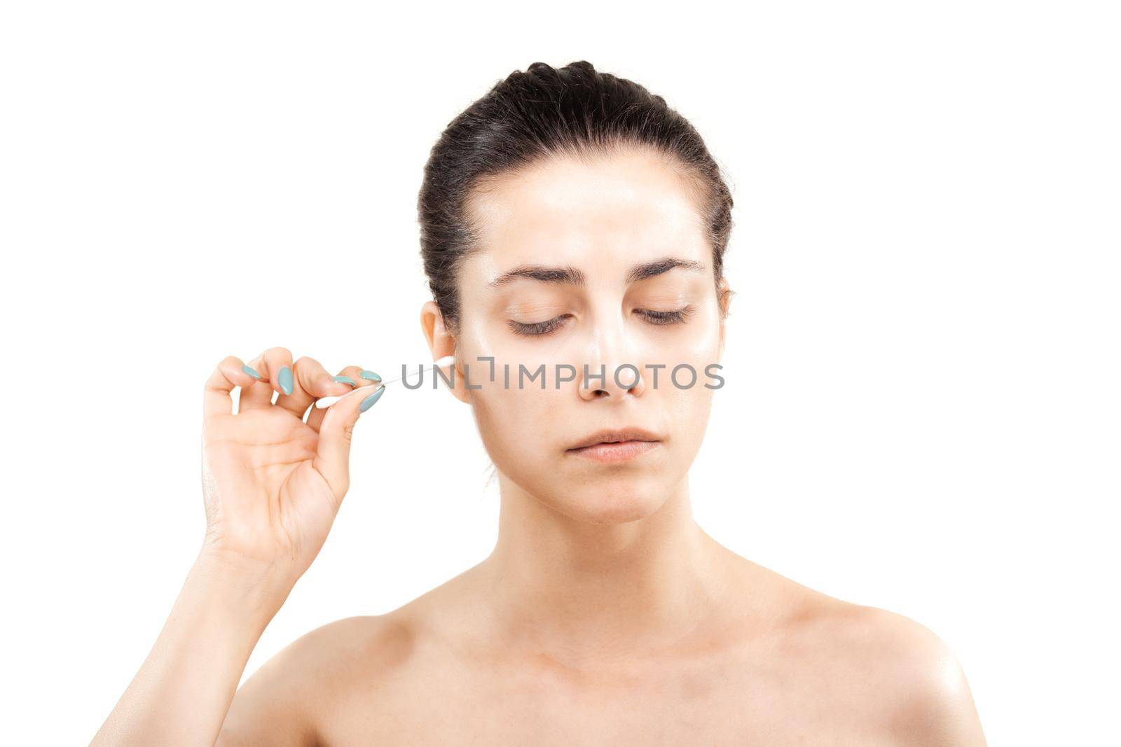 girl cleaning her ear with cotton stick