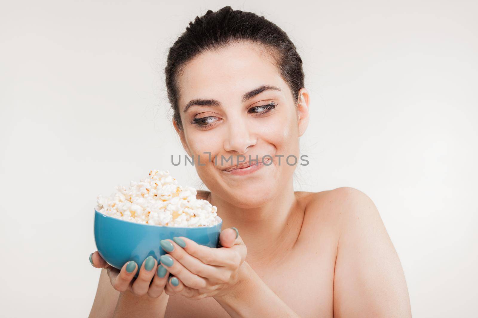 beautiful girl eating popcorn, happy satisfied expression by kokimk