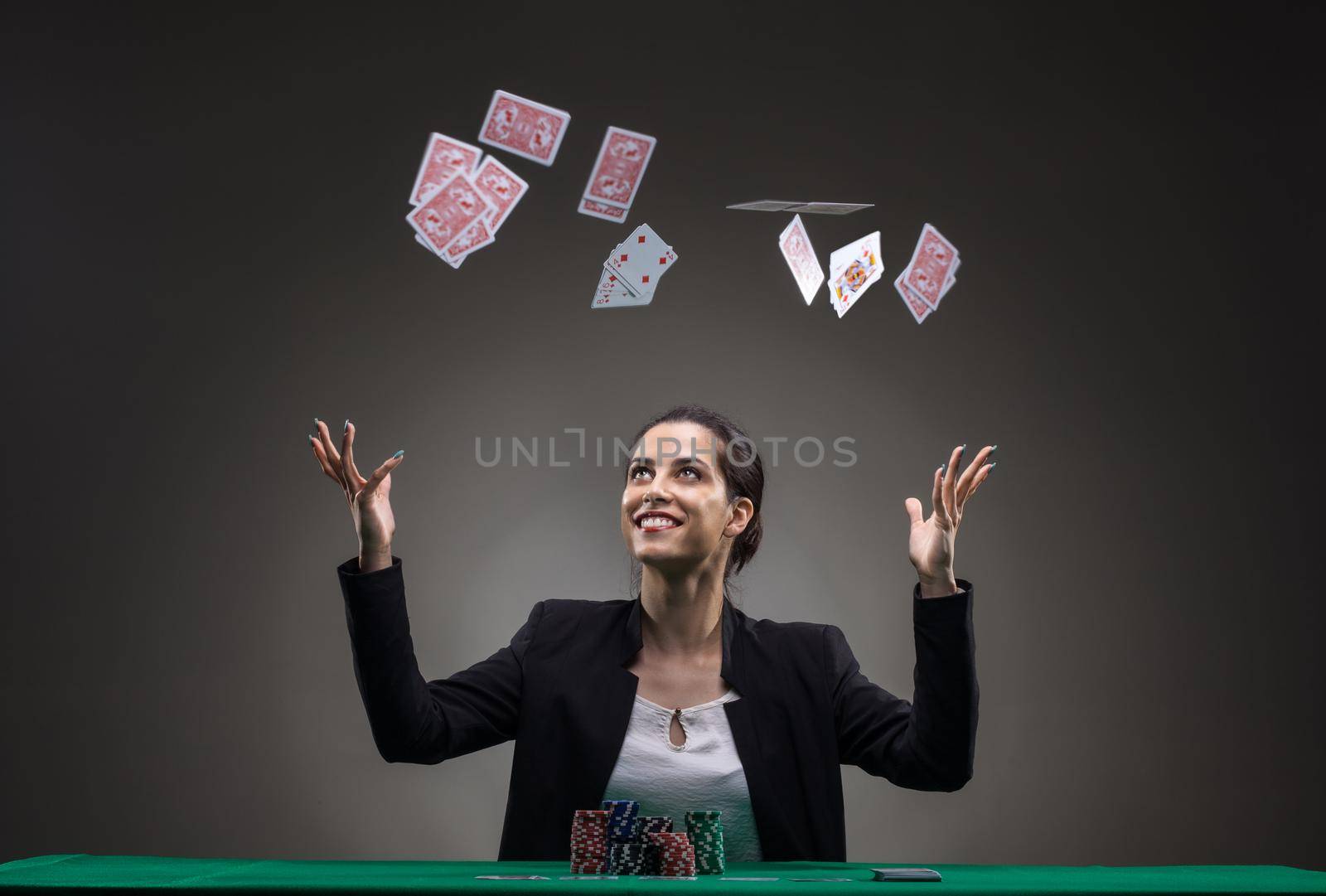 Girl playing poker. Throwing cards in the air by kokimk