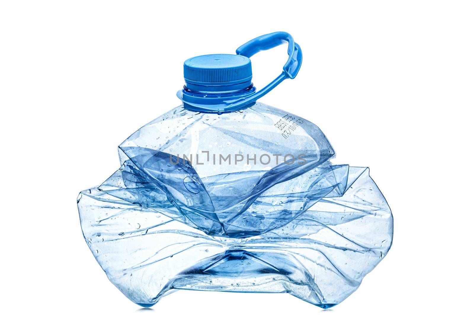 smashed empty plastic bottle with blue cap, isolated on white background. by kokimk