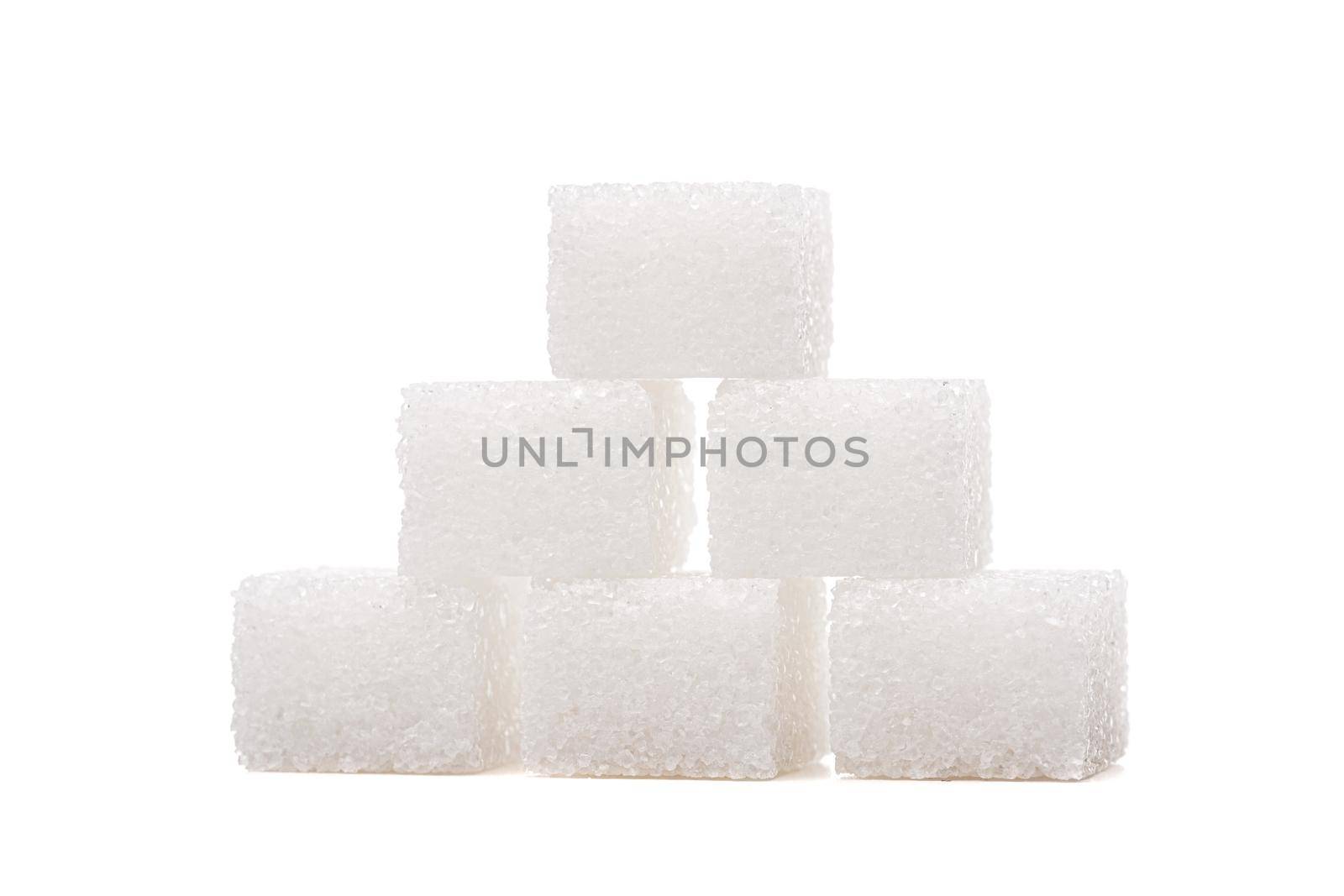 Sugar cubes on one another, isolated on white background
