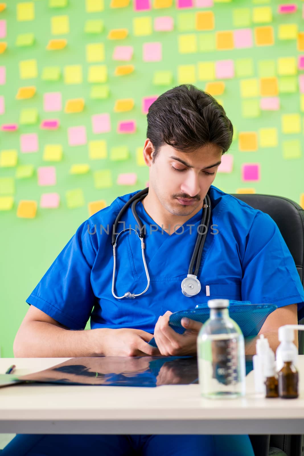 Young doctor with many reminders and urgent work