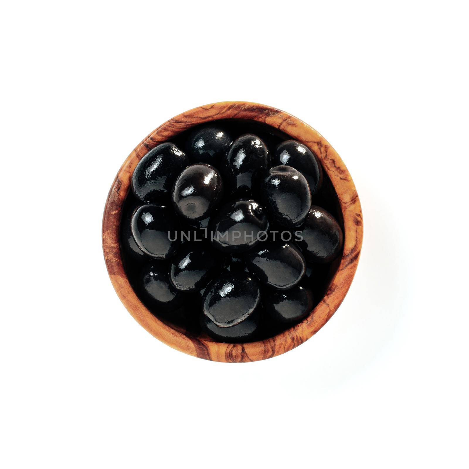 Black olives in wood bowl isolated on white by fascinadora