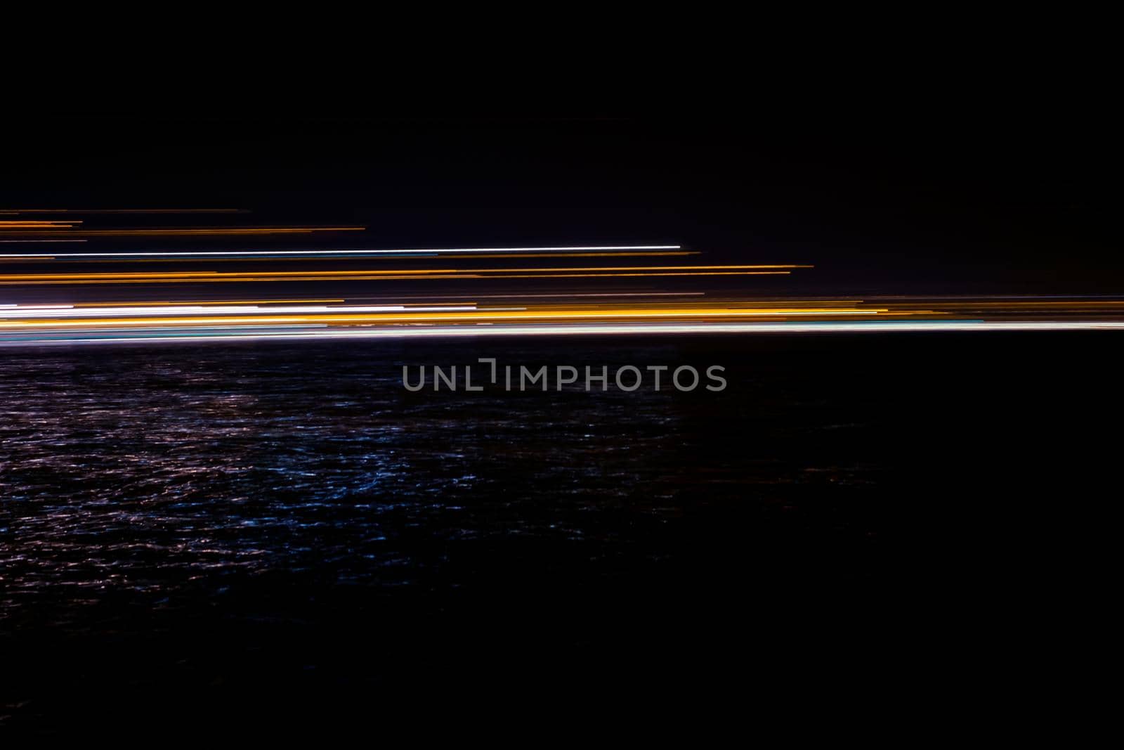 abstract lights in the dark reflected in water by Roberto
