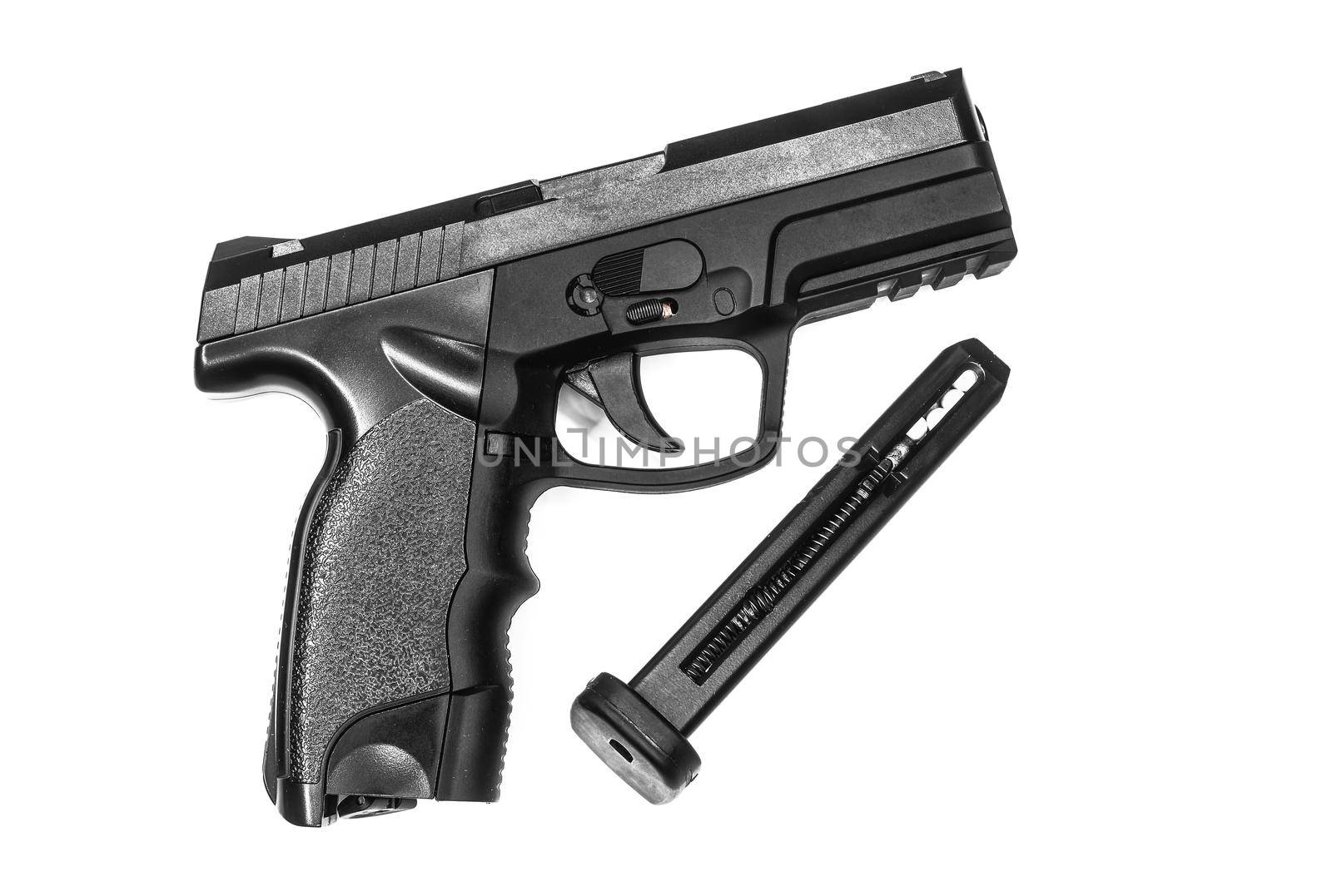 Black Airsoft gun and  bullets magazine on white background