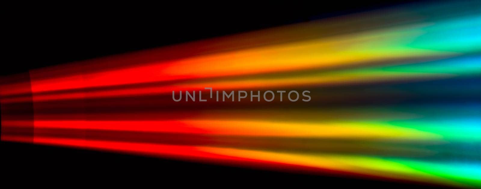 Colourfull burst of prismatic light creating rainbow on compact disk,  soft focus