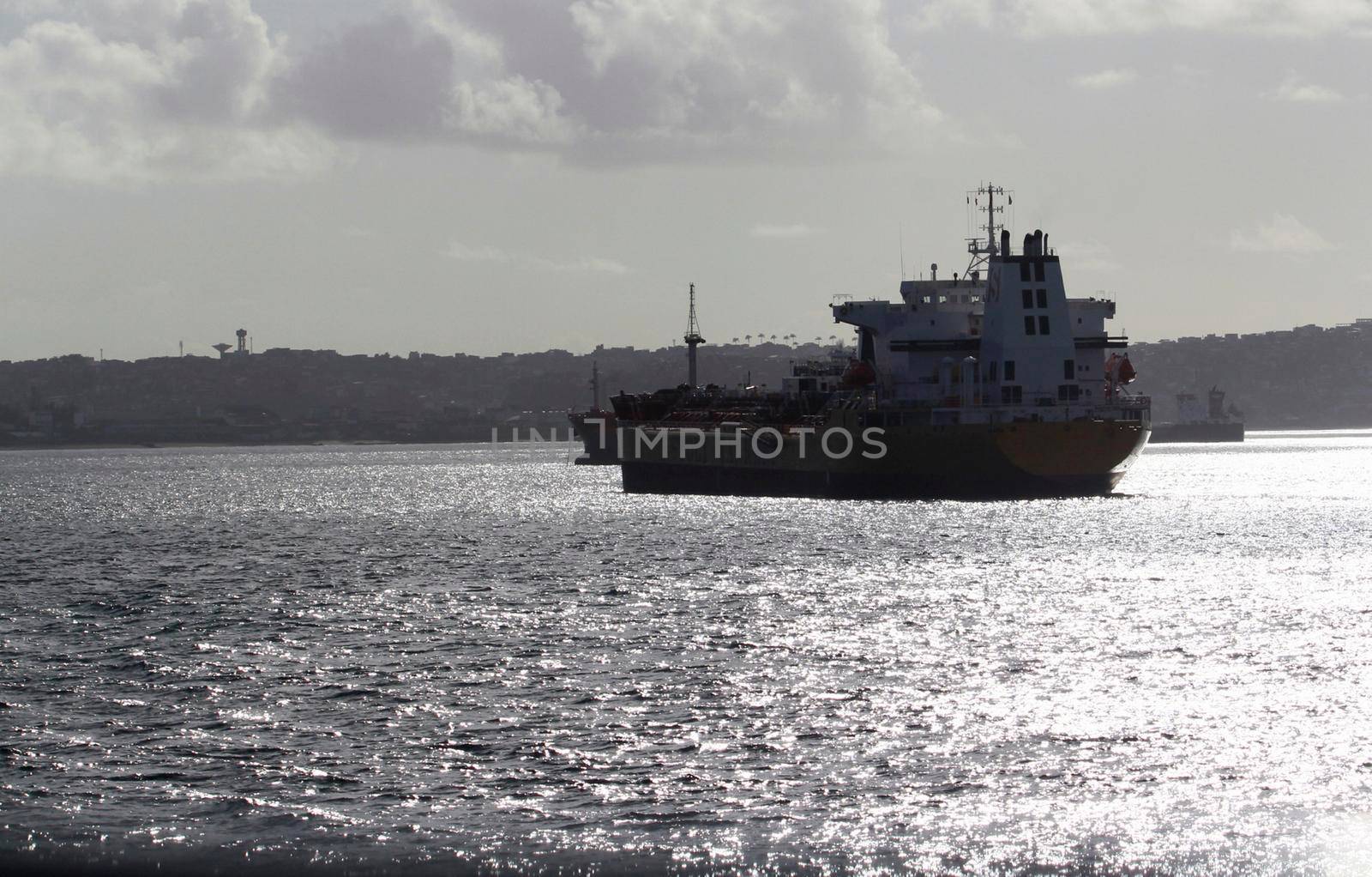 salvador, bahia, brazil - august 18, 2012: ship is seen anchored in waters of Baia de Todos os Santos in the city of Salvador.