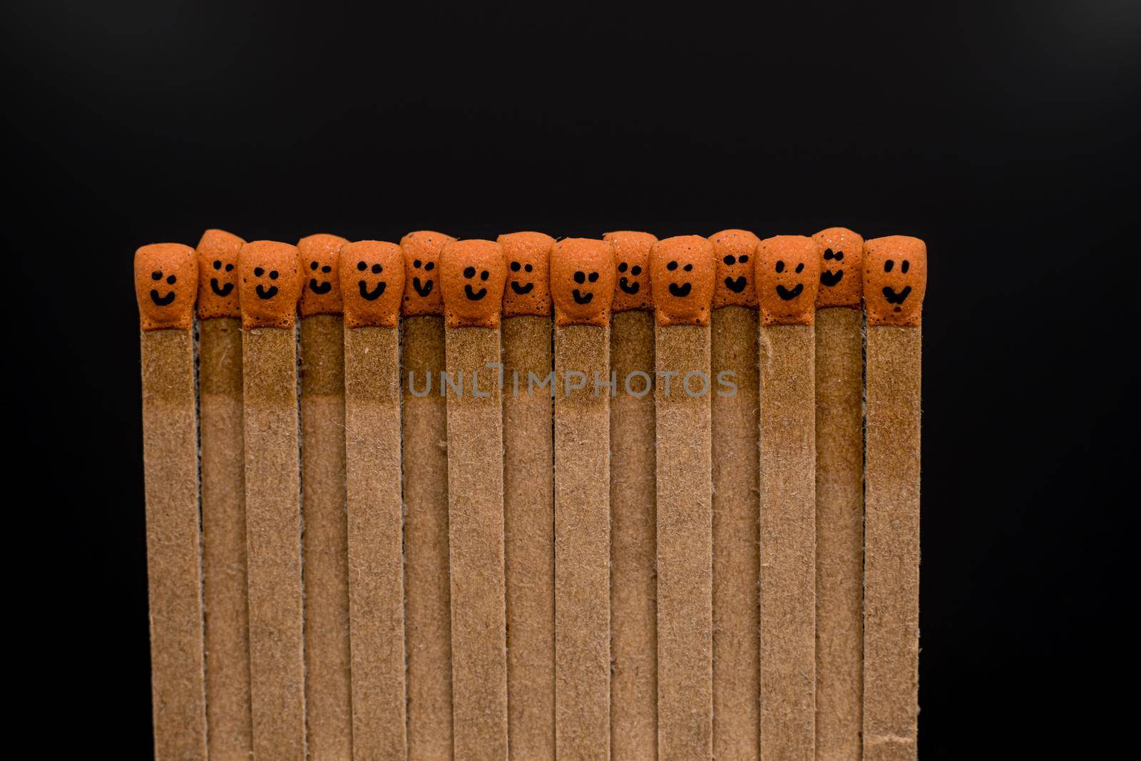 matchsticks with faces painted on the heads by Roberto