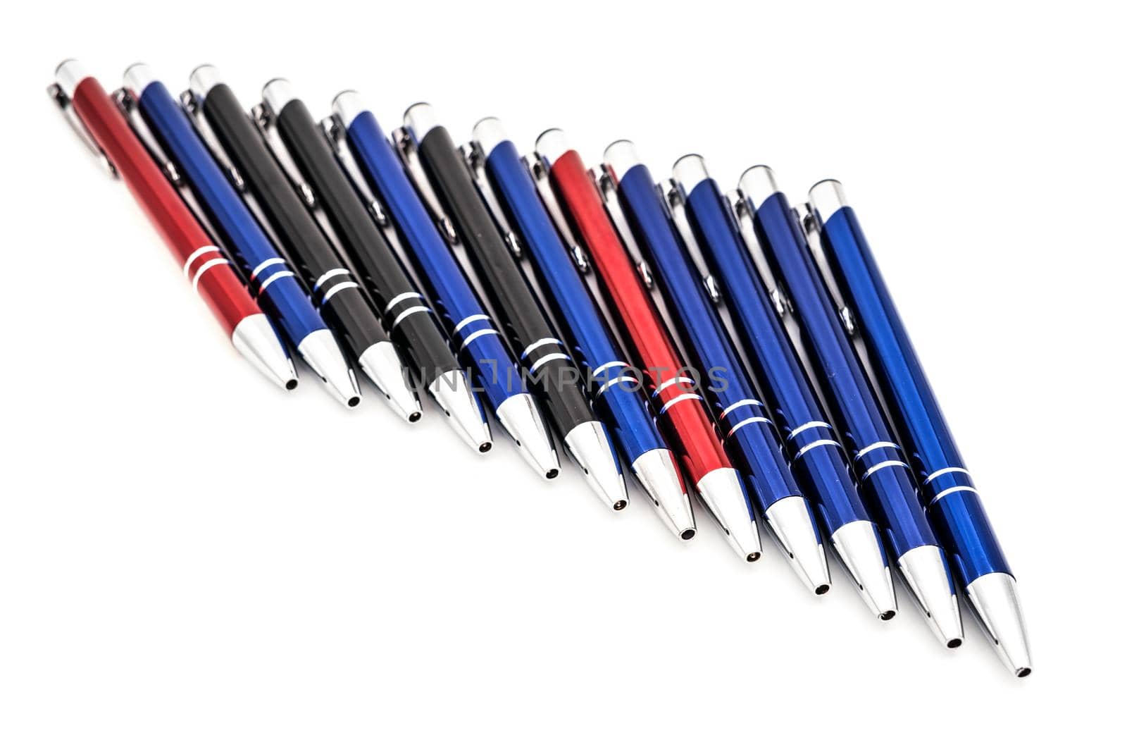 metal pens arranged on white background by Roberto