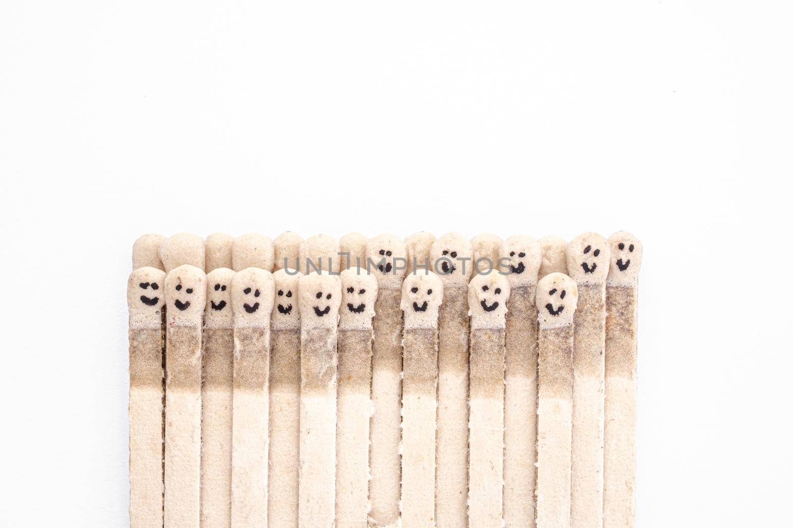 Multicolored matchsticks with faces painted on the heads by Roberto