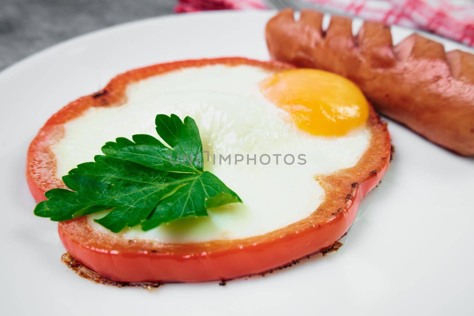 fried egg with red bell pepper on the plate.