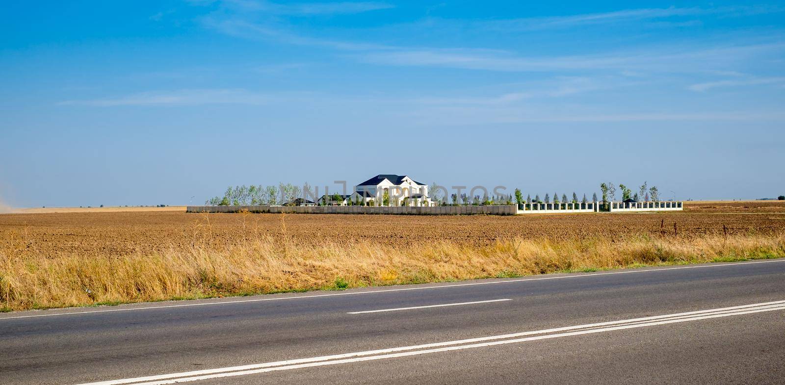 the house in the middle of the arable field near the road by Roberto