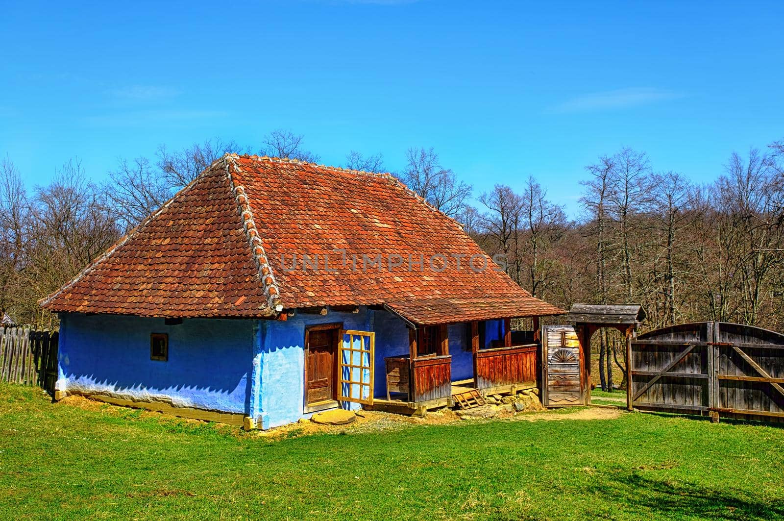 traditional Romanian clay house with grass yard