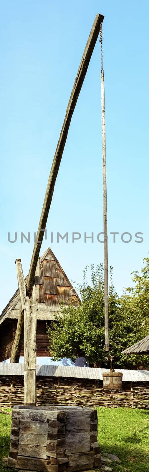Traditional Romanian well shadoof in an old village in Transylvania