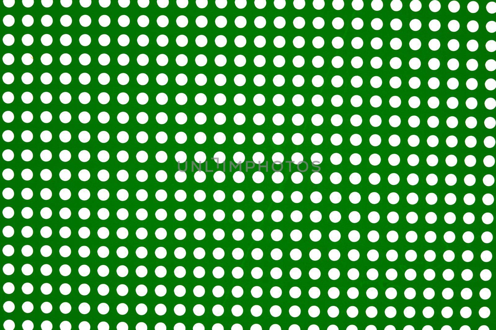white dots on a green background