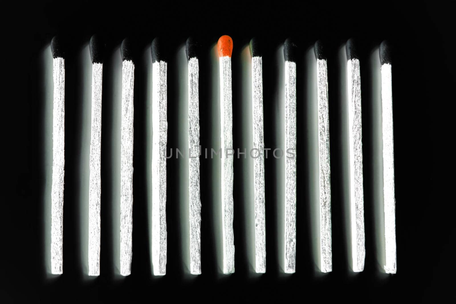 white matches with black heads and one with red head isolated over black