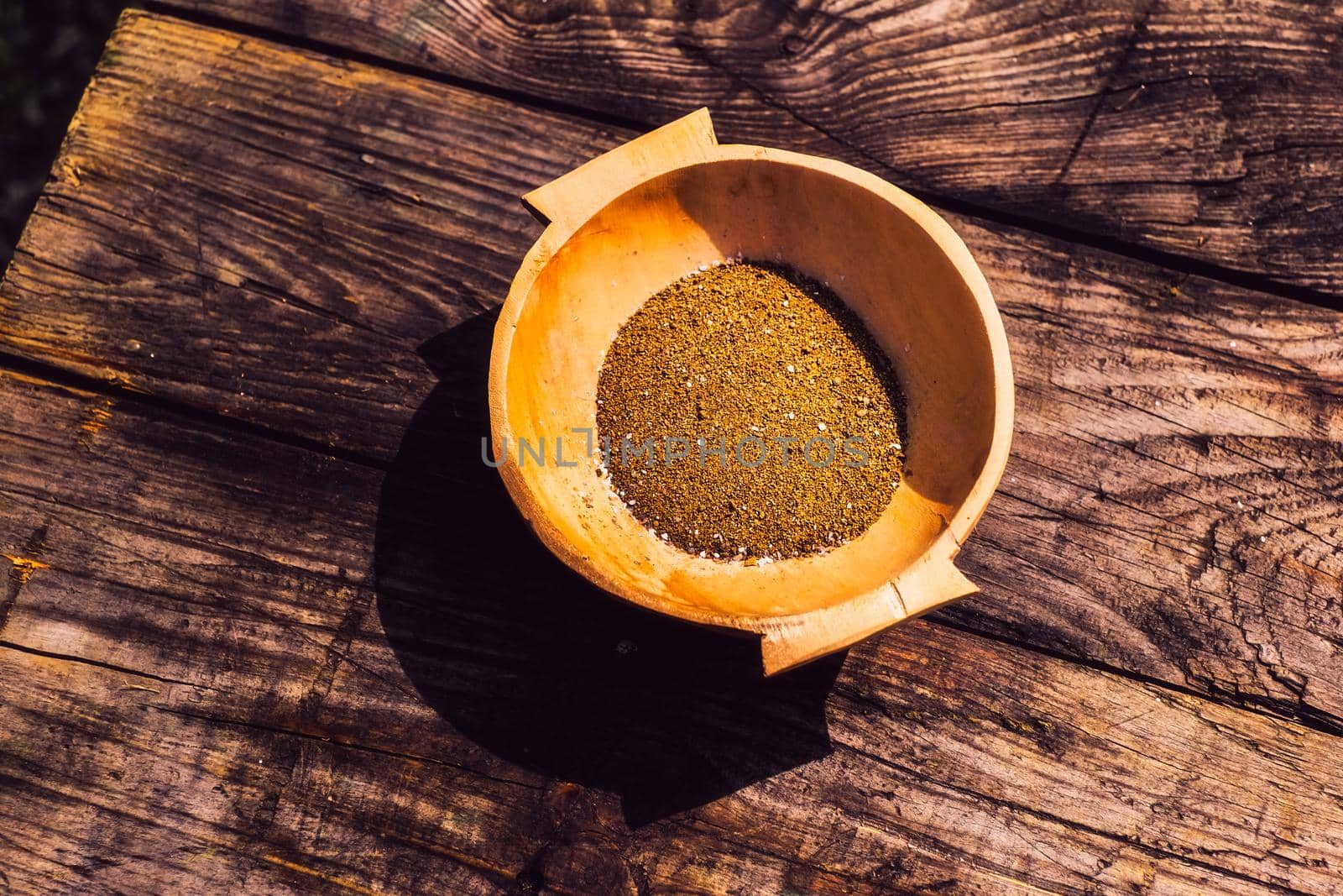 wooden bowl with sand on the old table