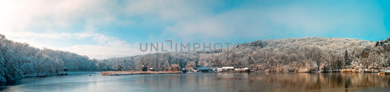 Winter panorama with windmills on a foggy winter day