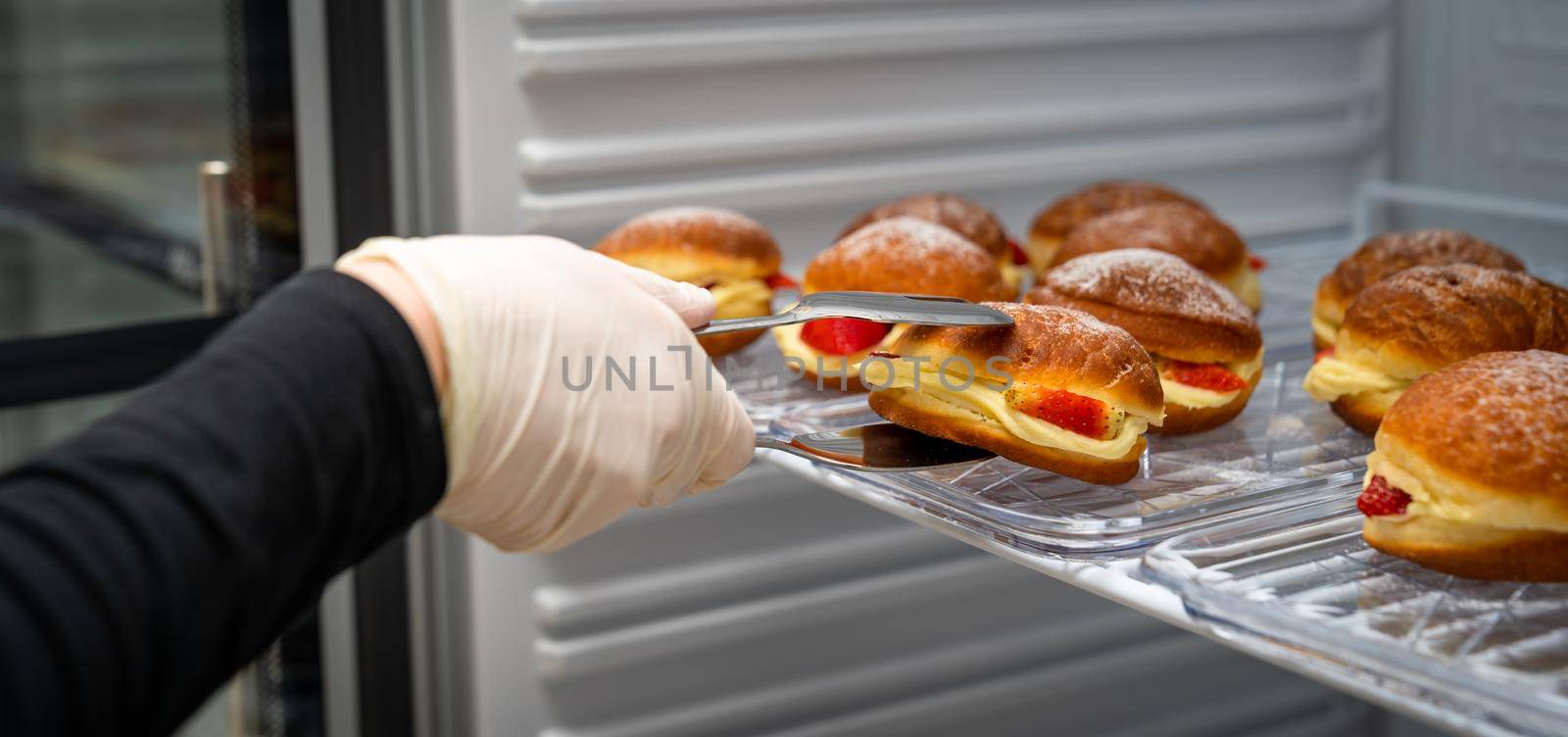 donut stuffed with cream and strawberries in the fridge.