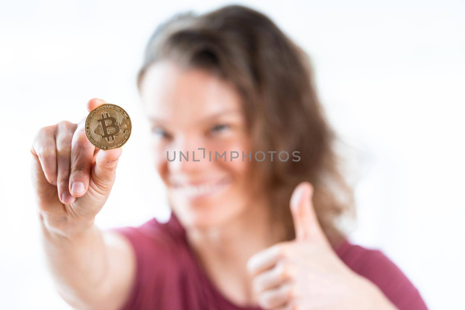 bitcoin coin in the hand of a young attractive business woman.