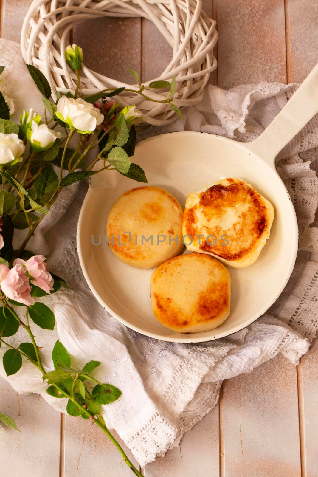 Cottage cheese pancakes, Syrniki on white shabby background. Homemade food.
