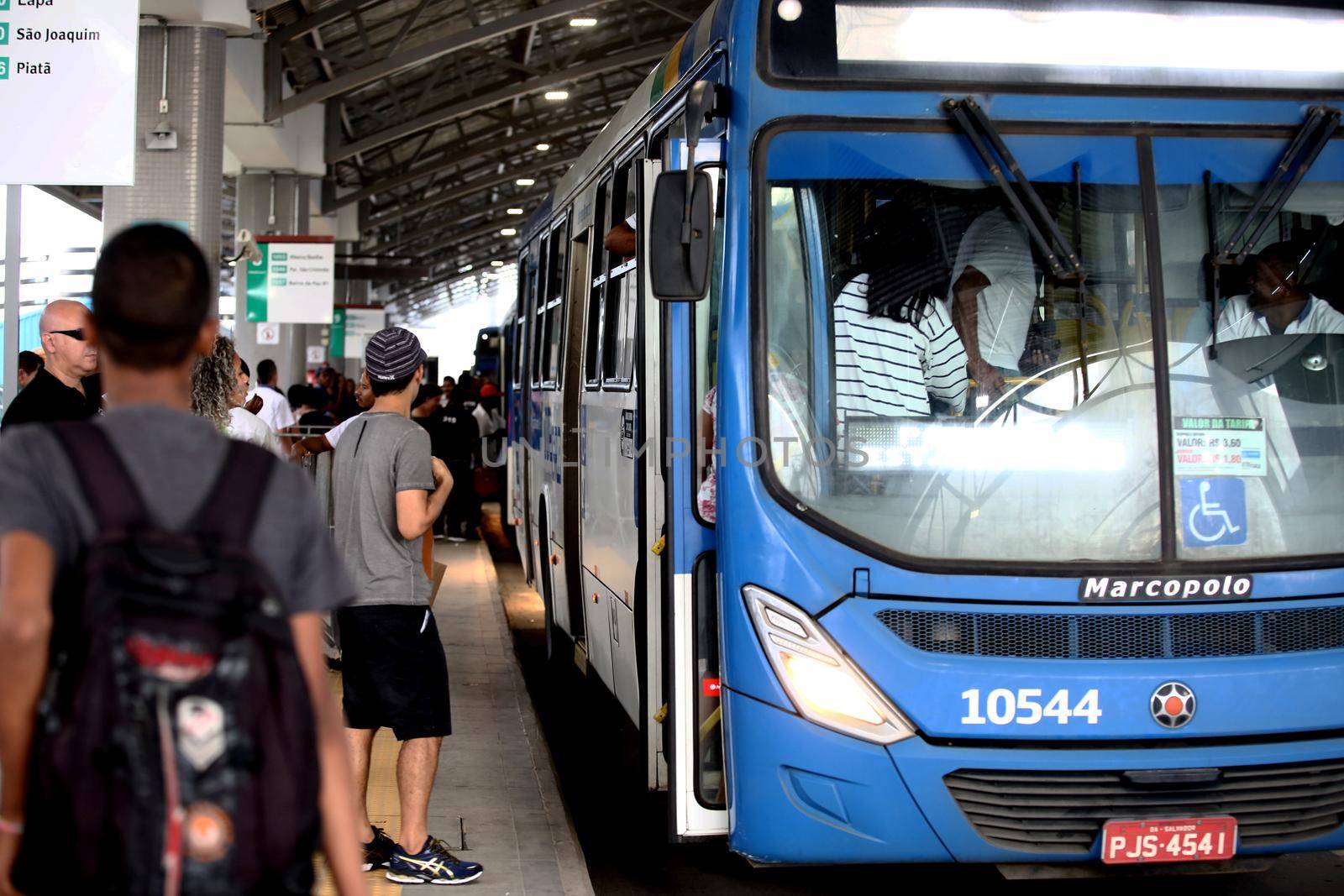 salvador, bahia / brazil - september 8, 2017: Passengers are seen during boarding buses at Estacao Mussurunga in the city of Salvador. The place serves as a transfer station in connection with line 2 of the city's metro.