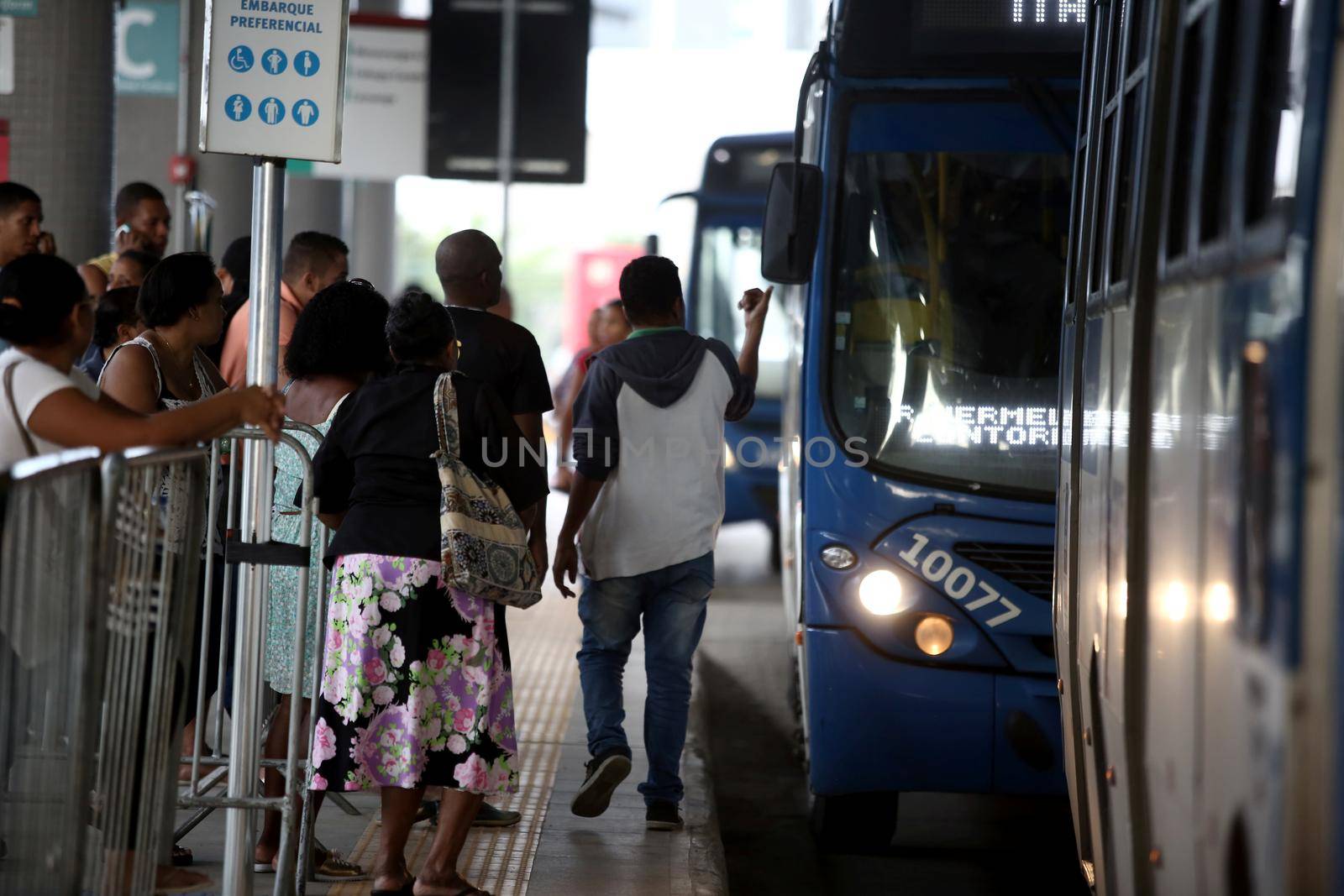 salvador, bahia / brazil - september 8, 2017: Passengers are seen during boarding buses at Estacao Mussurunga in the city of Salvador. The place serves as a transfer station in connection with line 2 of the city's metro.