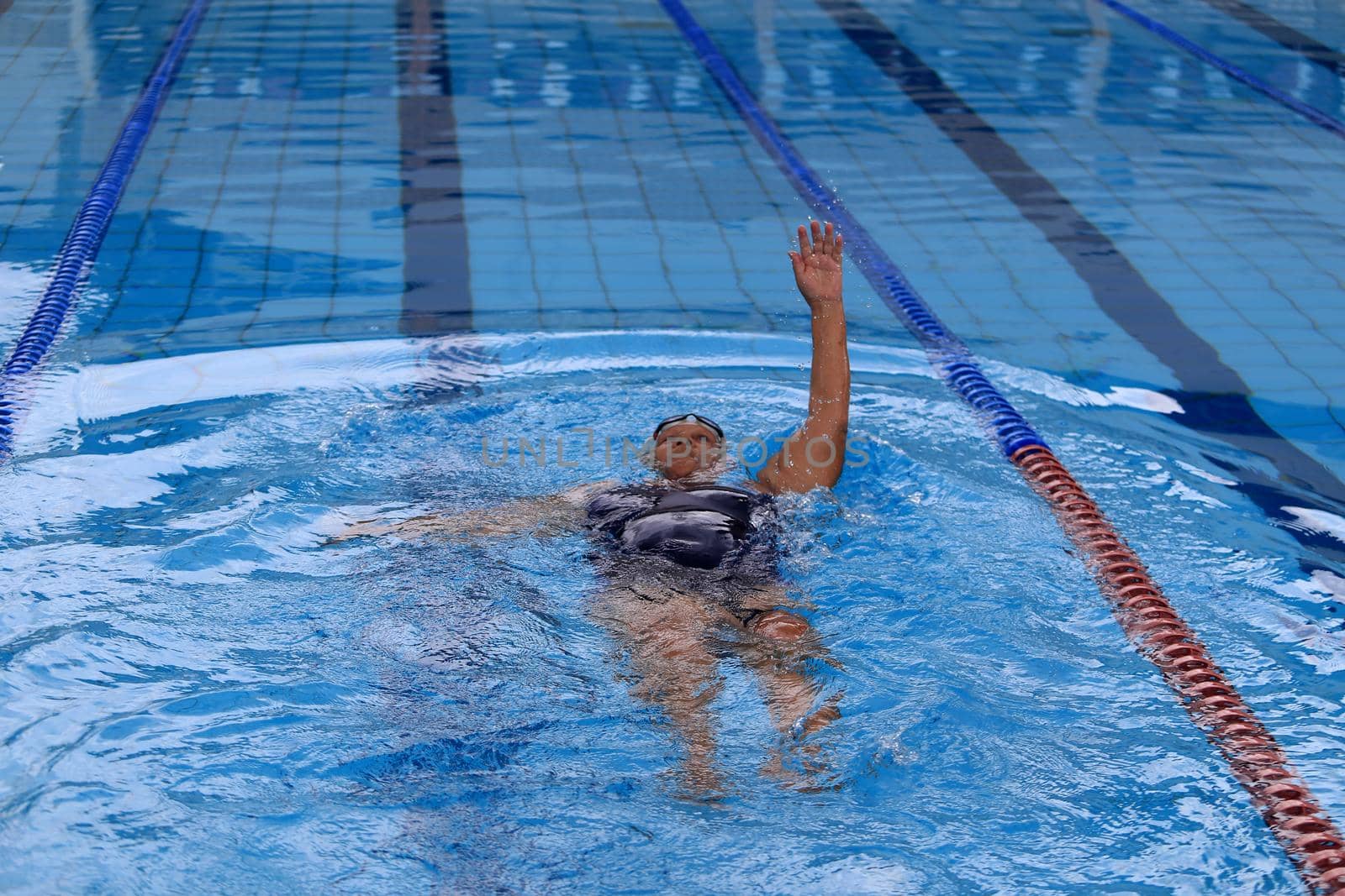 salvador, bahia / brazil - april 10, 2019: person is seen swimming in olympic pool in the city of Salvador.
