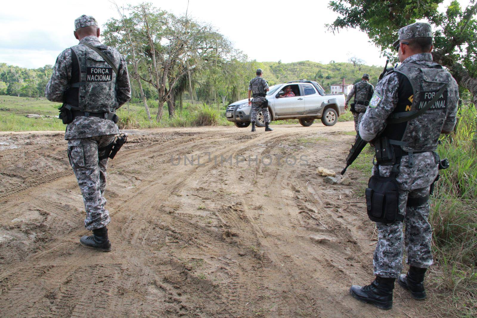 pau brasil, bahia / brazil - may 10, 2012: National Force military personnel approach vehicles and people traveling in rural Pau Brasil after armed conflict between Pataxo Hahahae ethinics and farmers .