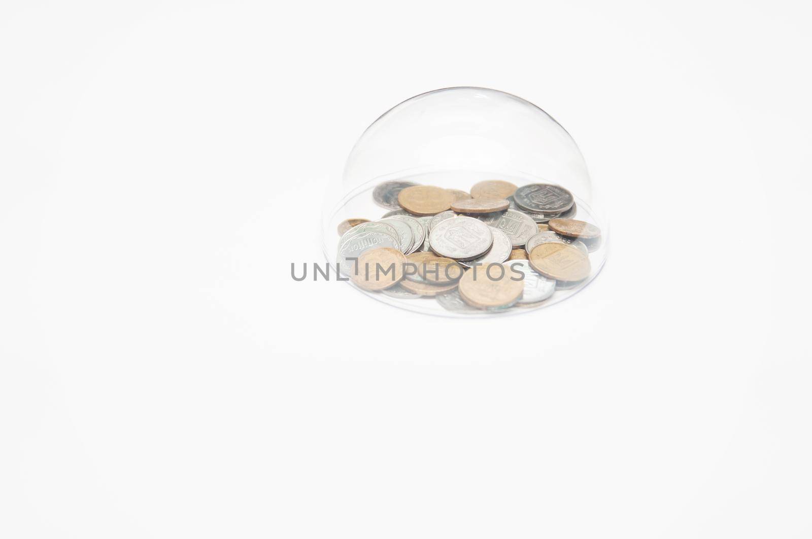 metal coins are grouped under a glass semicircle on a white background
