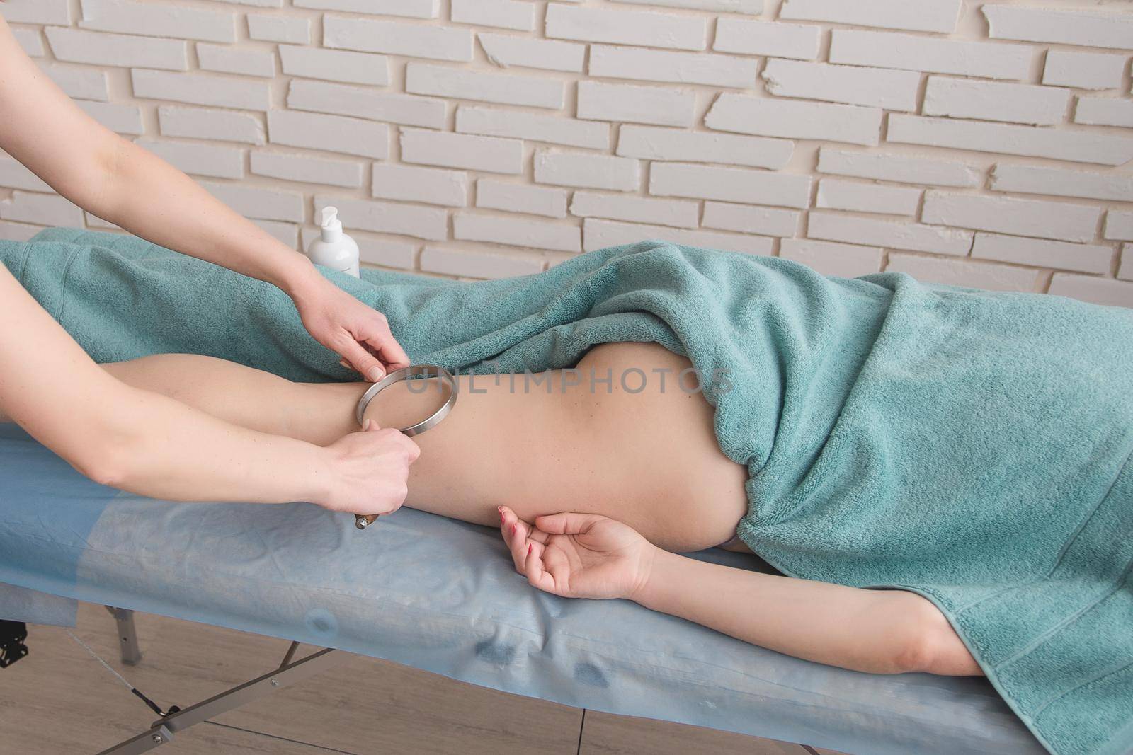 anti-cellulite foot massage in the spa salon makes the girl a cosmetology