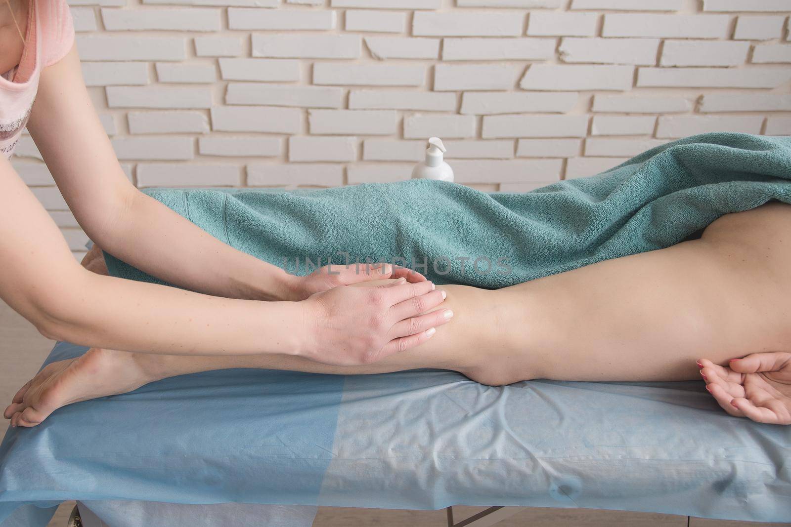 anti-cellulite foot massage in the spa salon makes the girl a cosmetology