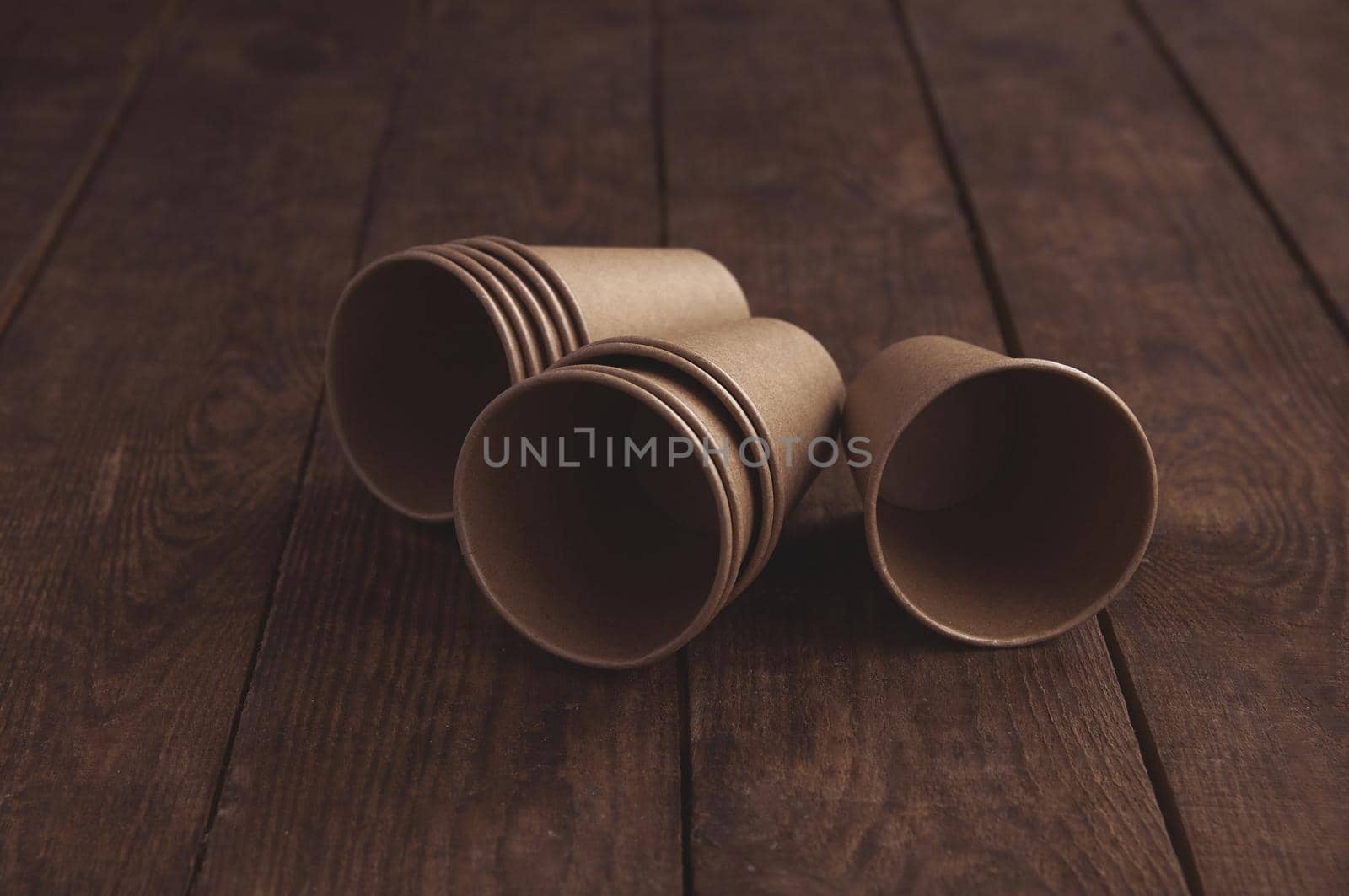 ecological kraft paper cups for coffee and tea dark brown on the table