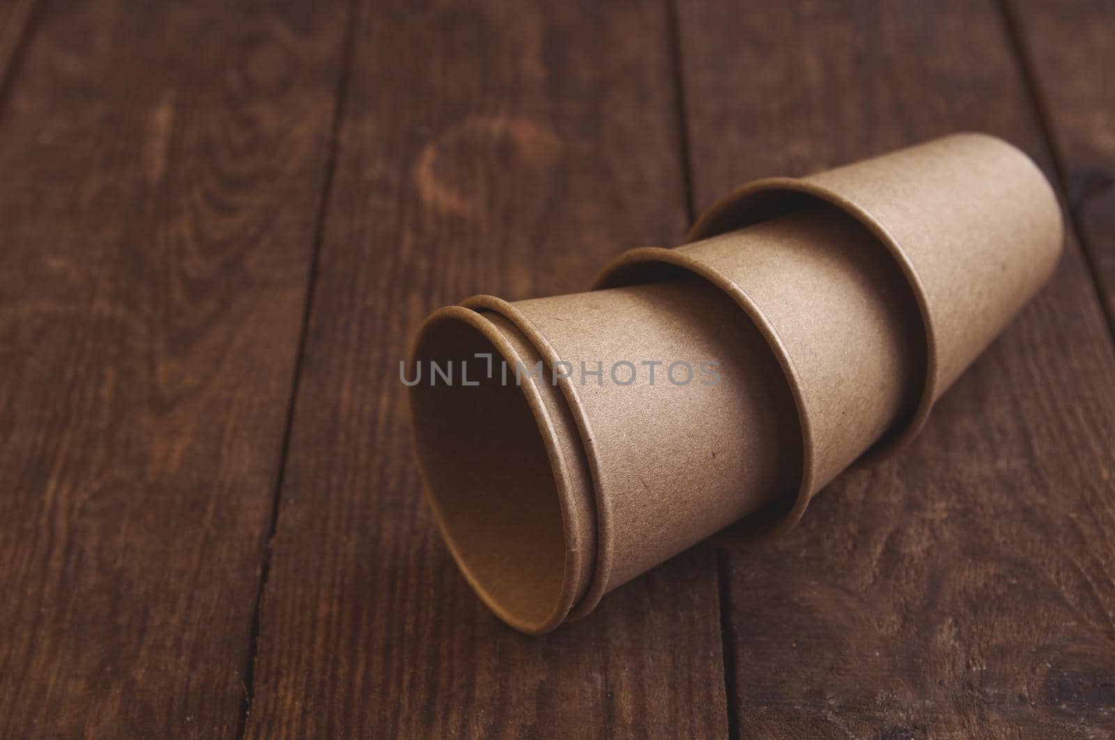 ecological kraft paper cups for coffee and tea dark brown on the table