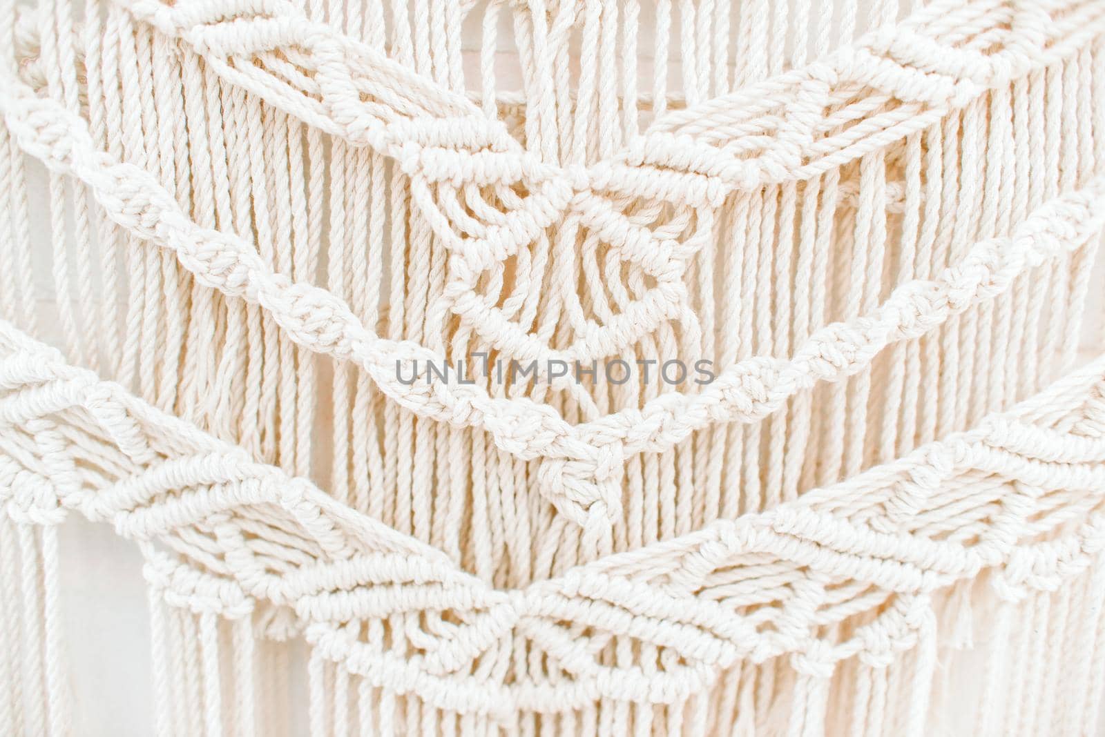 handmade macrame pattern a fragment of a wall panel in the boho style  by ozornina